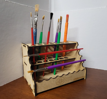 Load image into Gallery viewer, paintbrush holder with various colored paintbrushes on a wooden surface.