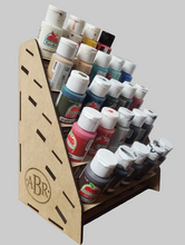Load image into Gallery viewer, Collection of paint bottles in a wooden organizer with ABR branding.
